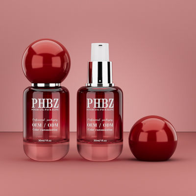 Botella de vidrio vacía de 30 ml / 1 oz con gradiente rojo y tapa de bola redonda, empaque personalizado de color OEM ODM para cuidado de la piel para loción y aceite esencial