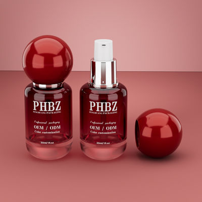 Botella de vidrio vacía de 30 ml / 1 oz con gradiente rojo y tapa de bola redonda, empaque personalizado de color OEM ODM para cuidado de la piel para loción y aceite esencial